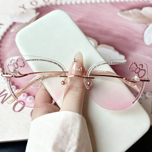 Adorn your look with our coquette pink glitter bow rimless cat-eye glasses! Featuring delicate bowknot and pearl accents, sparkly trim, and lightweight rose gold temples. Perfect for kawaii, Y2K, and soft girl aesthetics. Shop now!