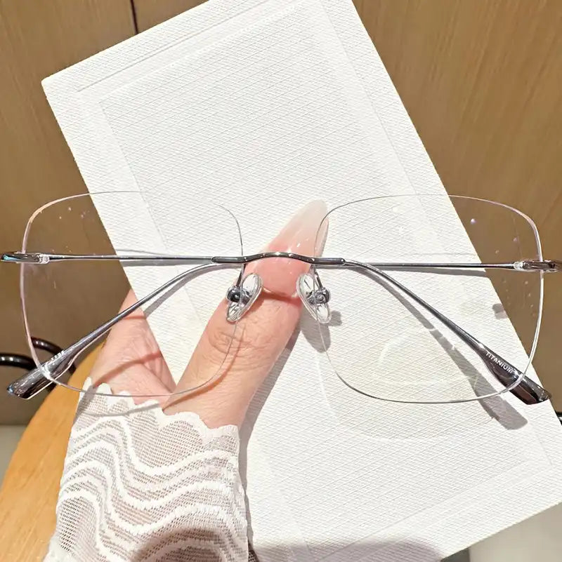 Embrace quiet luxury with our silver titanium rimless square glasses! Made with premium ultra-lightweight titanium for all-day comfort. Features a sleek oversized frameless design perfect for office siren & clean girl aesthetics. Shop now!