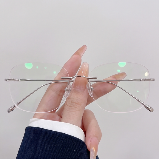 Upgrade your workday look with our silver rimless rectangle glasses! Featuring an ultra-lightweight titanium build and oversized frameless clear lenses for maximum comfort and face-framing style. Perfect for office siren & quiet luxury aesthetics. Shop today!