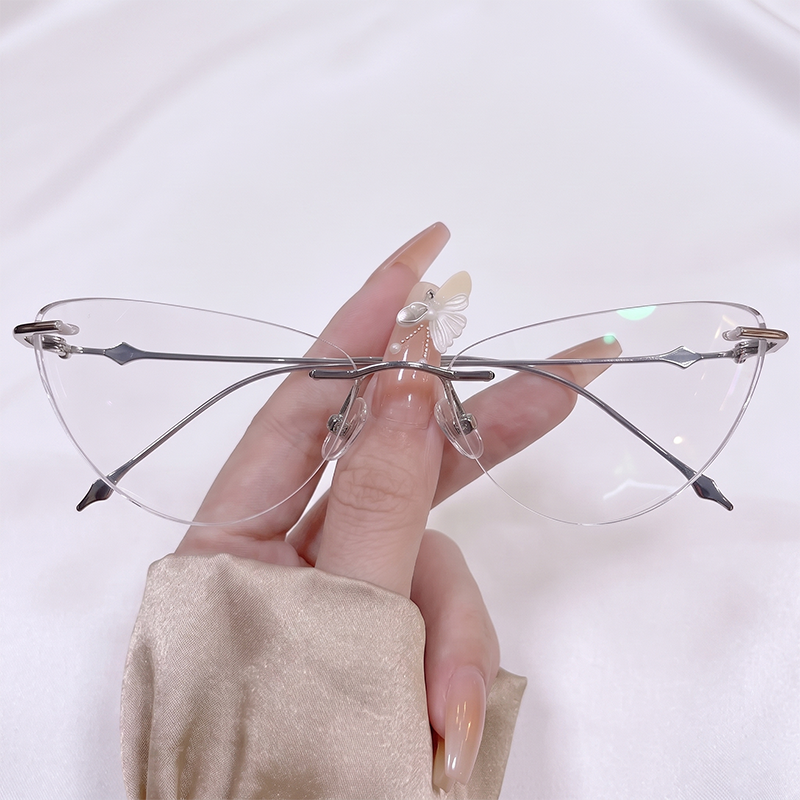 Shop our Y2K rimless butterfly glasses featuring a delicate silver metal frame and clear cat-eye winged lenses. Perfect for fairycore & coquette aesthetic lovers. Free shipping available!