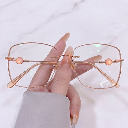 Elevate your gentle romantic style with our rose gold glitter edge rimless glasses! Featuring an oversized soft square silhouette, sparkling glitter border, and charming peach opal bead temple details. Perfect for coquette & fairycore aesthetics. Shop now!