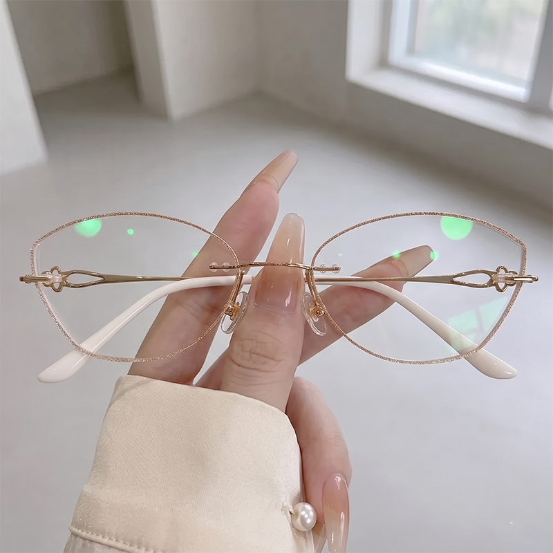 Exude intellectual chic style with our rose gold cat eye rimless glasses! Featuring a shimmering glitter edge cut lens, delicate floral cutout temple details, and elegant white temple tips. Perfect for office siren outfits & everyday glam. Shop now!