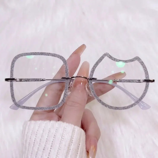 Stand out from the crowd with our quirky asymmetric silver glitter rimless glasses! Featuring a show-stopping mismatched design—one soft square lens and one adorable cat head lens—wrapped in chunky sparkling silver glitter. Perfect for Y2K, festival outfits & unique aesthetic looks. Shop now!

