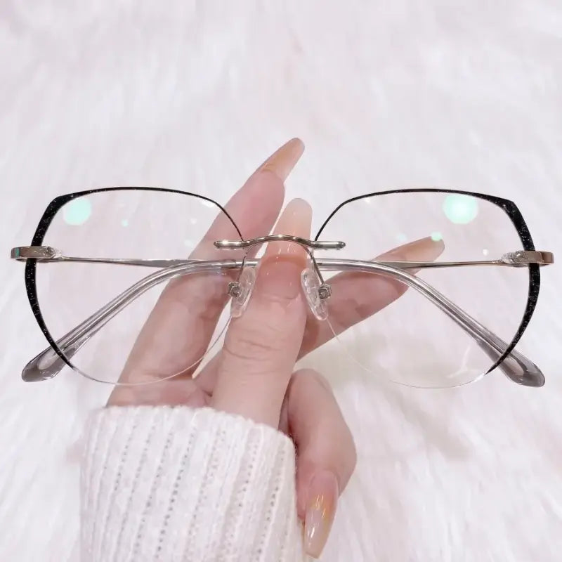 Add a touch of mysterious glam to your look with our black glitter edge rimless glasses! Featuring an oversized soft square silhouette, sleek silver metal temples, and a shimmering starry black border. Perfect for office siren, soft goth & chic everyday outfits. Shop now!